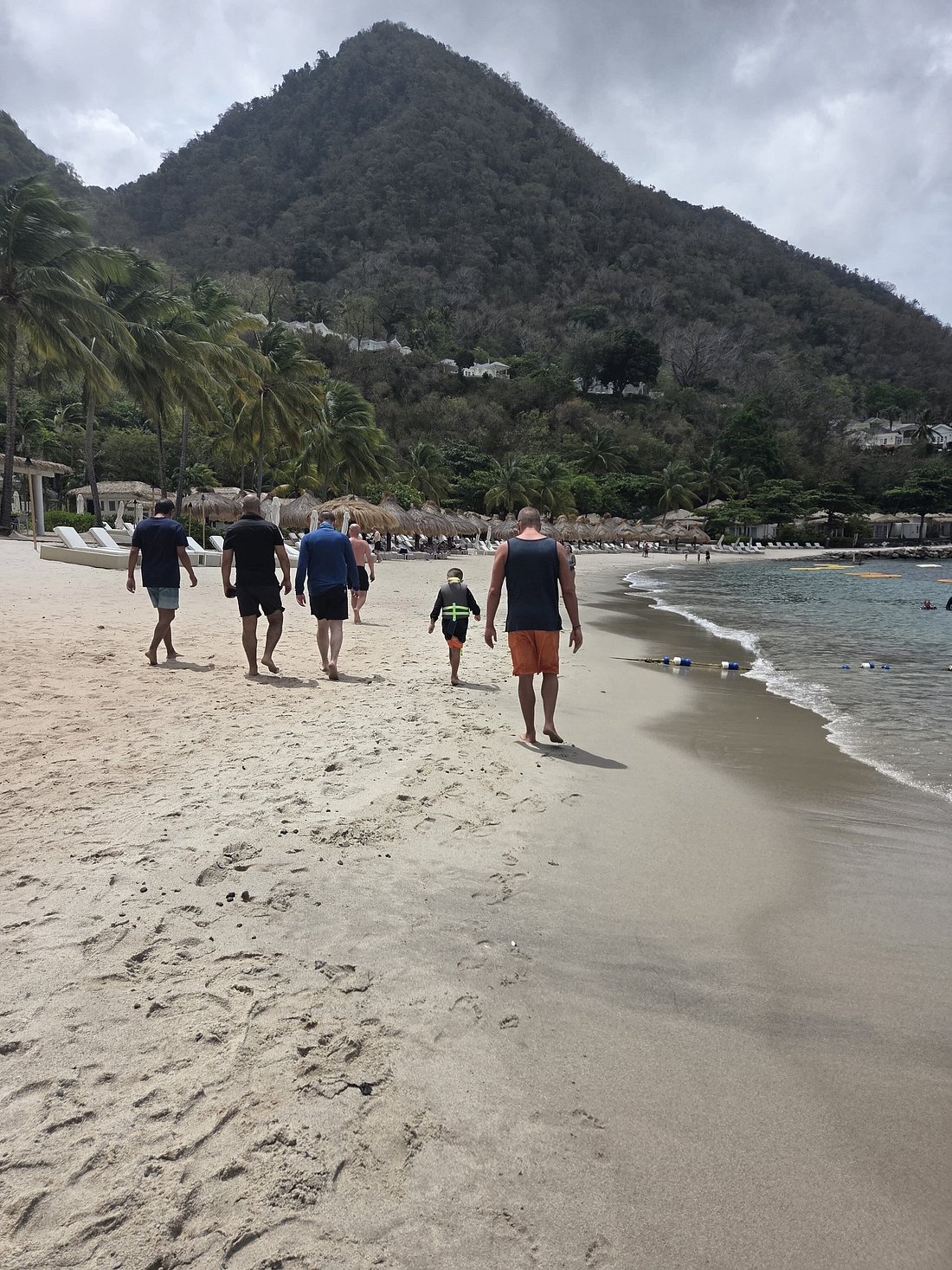Group walking Sugar Beach between the Pitons near Soufriere, St. Lucia
