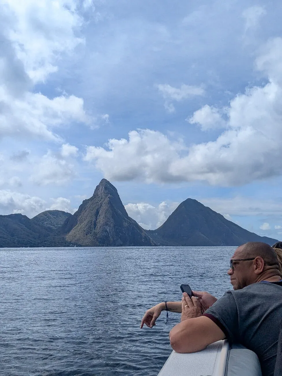 Guest photographing the Pitons from the deck of the Timeless II speedboat